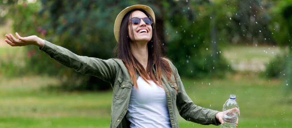 Portrait of beautiful young woman enjoying summer with water.